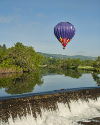 Hot Air Balloon over the waterfall in Quechee, Vermont